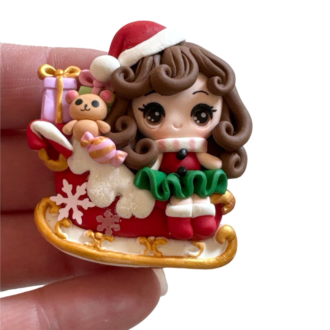 Christmas Girl with Santa Hat on Sleigh Bow Clay from Temptress Maker