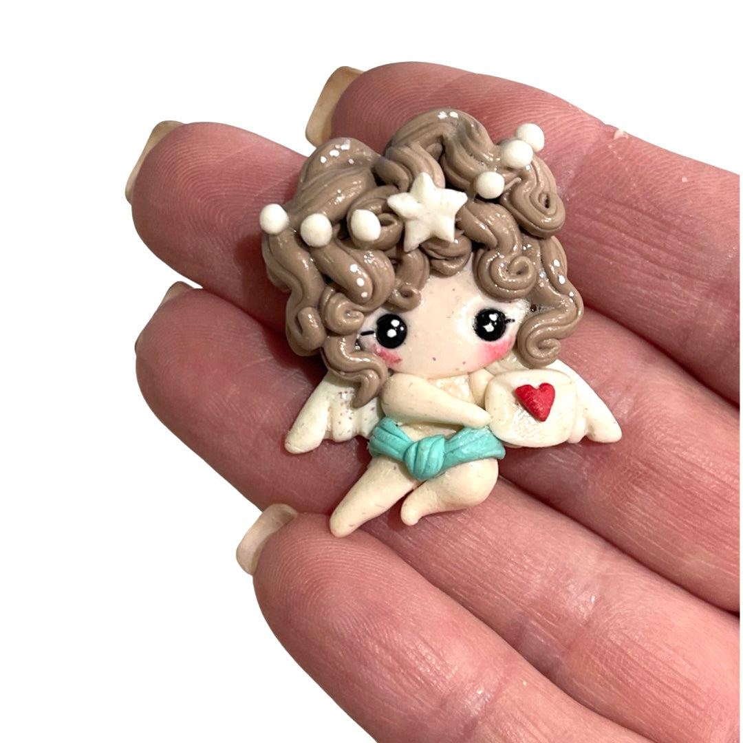 Embellissement d’argile d’arc de Cupidon