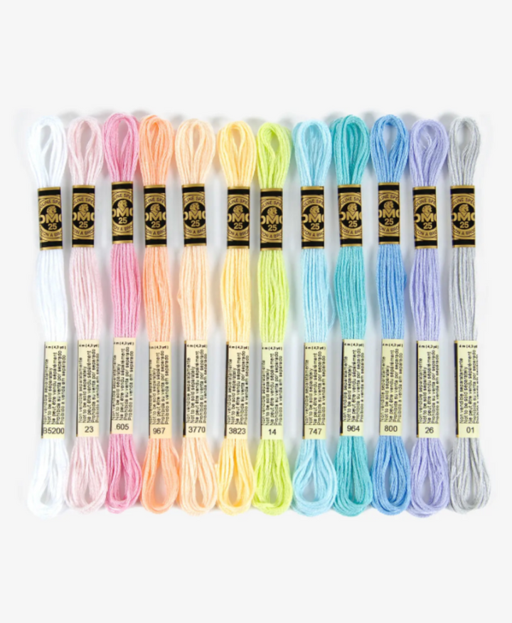 Set of 10 skeins of embroidery thread in pastel colors with DMC labels.